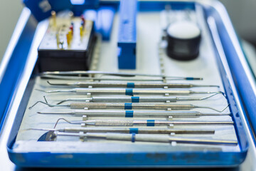 Tray of metal dental tools used by dentists in the field of dentistry. Shallow depth of field