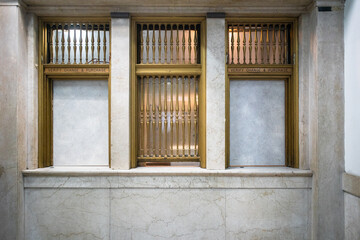 Out of service vintage post office facility interior with windows and bars. 