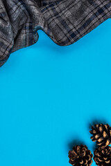 Board for an inscription. Checkered fabric frame and bumps on blue paper background