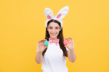 Easter eggs hunt. Attractive cheerful smiling girl in bunny ears celebrating Easter.