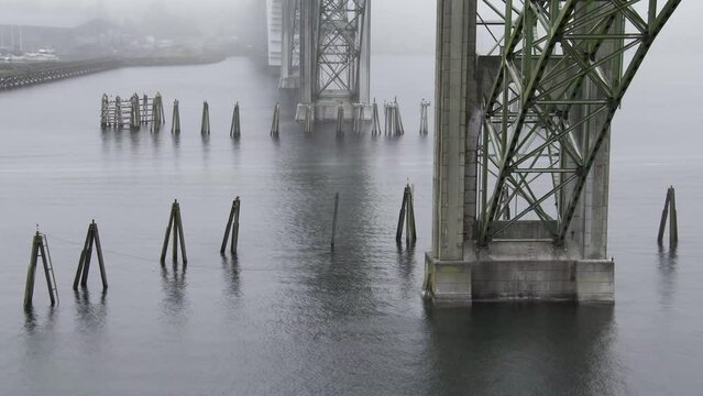 Drone Aerial Video Yaquina Bay Bridge Newport Oregon Coast Fog 02 Time Lapse of boats crossing under the Yaquina Bay Bridge in the fog