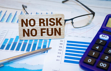 the inscription no risk no fun on the background of economic graphs
