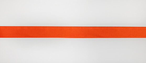 Straight red ribbon on white background, design element for gift decoration.