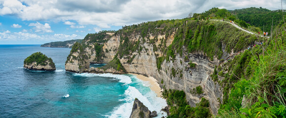 Atuh Beach is a Rustic, isolated cove beneath a sheer cliff face, with a sandy beach offshore rock...