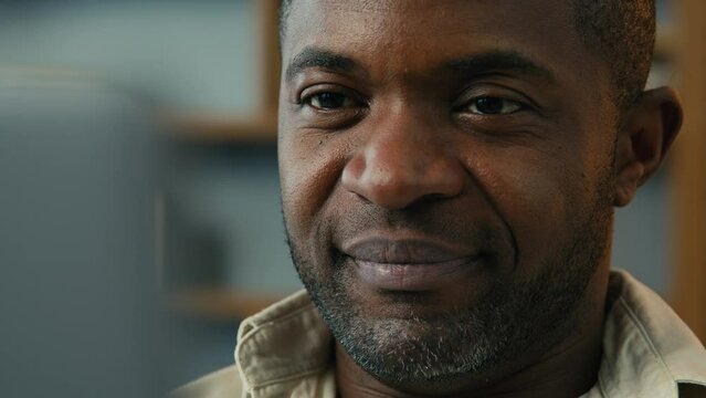 Portrait mature african american man looking laptop screen browsing email working online at home using computer close-up happy smiling male face ethnic businessman freelancer work remote on internet