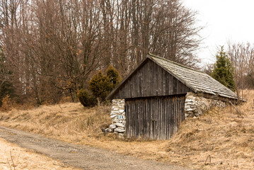 mountain wooden hut late winter in spring