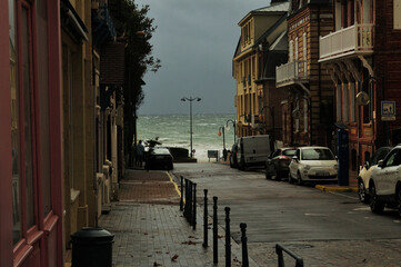 Fototapeta na wymiar Street Leading To The Wild Sea In Villers-sur-Mer Normandy France On A Beautiful Sunny Summer Day With A Few Clouds In The Sky