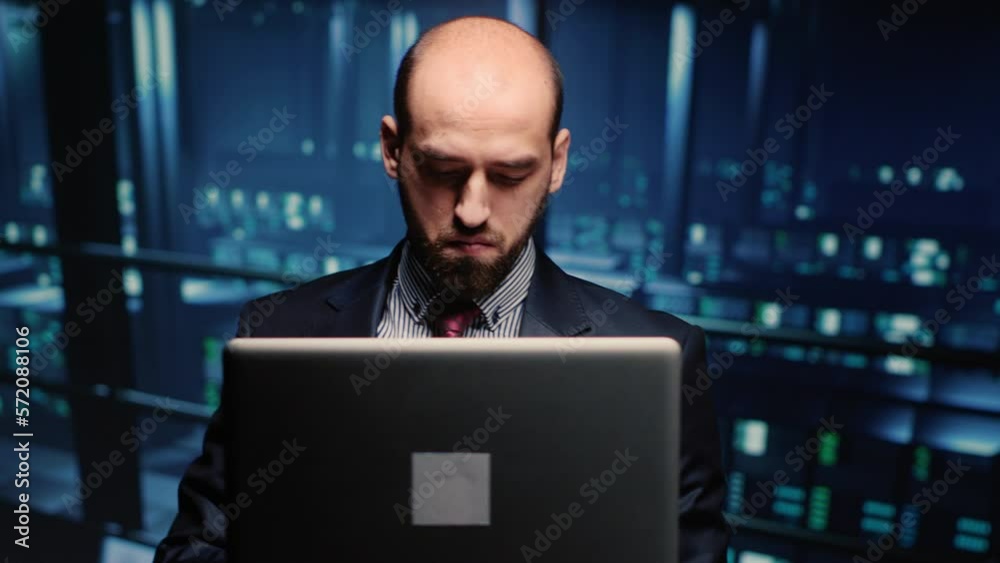 Poster system administrator checking cluster computer service holding laptop in modern server room. data ce