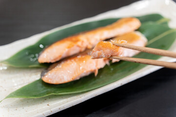 北海道産の焼き鮭を箸で持ち上げている