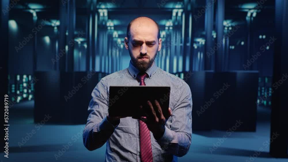 Poster male infrastructure specialist using tablet for hardware digitalization, inspecting cloud computing 