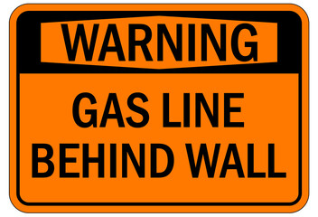 Pipeline sign and labels gas line behind wall