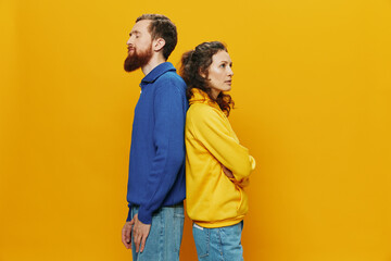 Obraz premium Man and woman couple smiling cheerfully and crooked with glasses, on yellow background, symbols signs and hand gestures, family shoot, newlyweds.