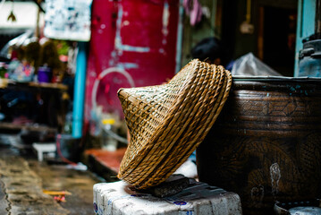 Chinese bamboo woven hats beside dragon jars in Yaowarat community, Bangkok, Thailand