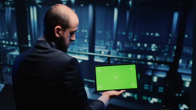 IT administrator running greenscreen display on tablet, using cloud computing in render farm. System technician working with isolated template and chroma key copyspace, artificial intelligence.
