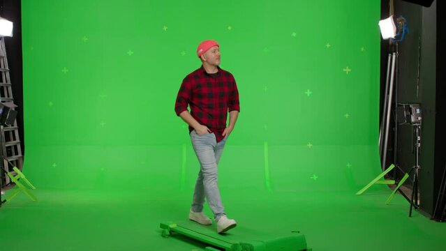 Young casual man walking on a Green Screen, Chroma Key.