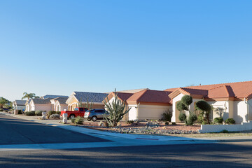 Typical southwestern single family housing community  with low watering xeriscaped front yards in...
