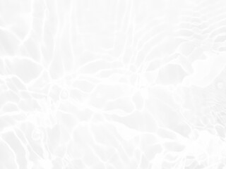 Defocus blurred transparent white colored clear calm water surface texture with splashes and bubbles. Trendy abstract nature background. Water waves in sunlight with copy space. White water shine