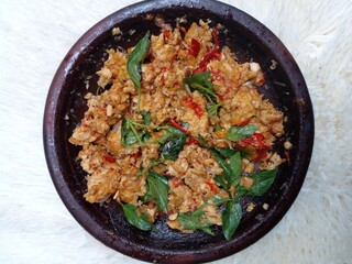 Sambal tempe. Tempeh, shallots, garlic and red chilies are fried then after being cooked mash with a mortar then add salt and basil leaves to make it more flavorful. Indonesian food. Closeup photo.