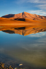 Fototapeta na wymiar Salt lake Lejia reflection, idyllic volcanic landscape at Sunset, Atacama, Chile