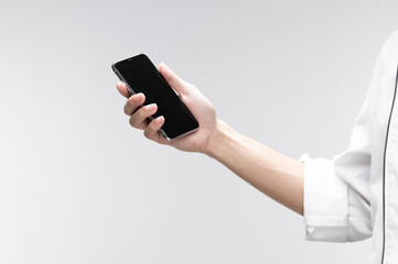 Man holding smartphone with blank screen on white background, can use model for application or your web design project. A mockup of a smartphone with a blank screen in hand