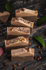 Pieces of fragrant coffee and chocolate soap on the wooden background. Concept of natural eco soap and cosmetics