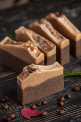 Pieces of fragrant coffee and chocolate soap on the black background. Concept of natural eco soap and cosmetics
