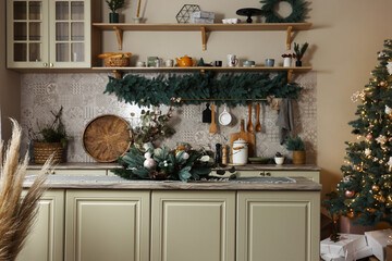 Stylish kitchen with festive decor and Christmas tree. Interior design