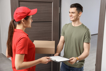 Man receiving parcel from courier at house entrance