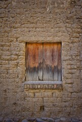 Pared de adobes y ventana de madera 
