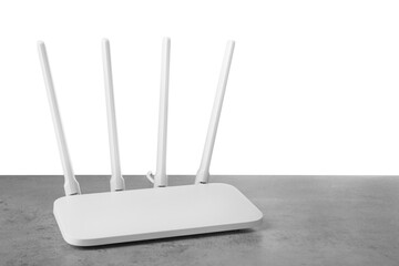 New modern Wi-Fi router on grey table against white background. Space for text