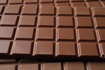 Delicious milk chocolate bars as background, closeup