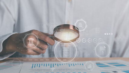 Businessman holding a magnifying glass,Audit Document Concepts, quality assessment management With...
