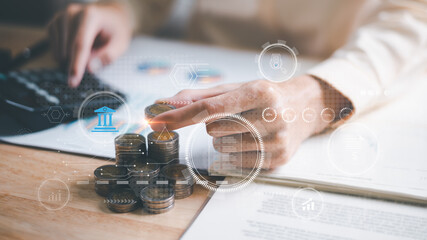 accountant putting money coins and calculate the numbers in the company's financial documents with a calculator, Planning to assess and review the budget, concept of finance and investment