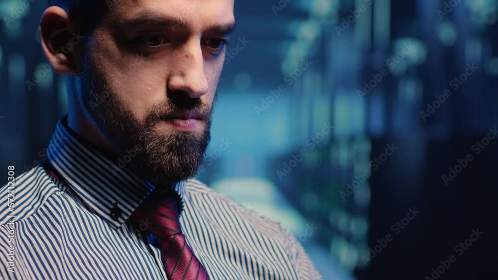 Poster system administrator standing in modern data center, checking supercomputer networking service on ta