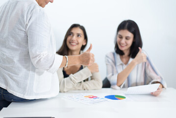 Businesswoman showing thumbs up and working in office.,Successful and teamwork concept