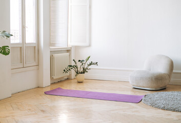 Empty living room with fitness mats on the floor
