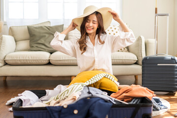 Portrait of beauty asian traveler woman packing stuff and outfit clothes in suitcases travel bag luggage for summer holiday weekend tourist vacation trip at home. travel concept
