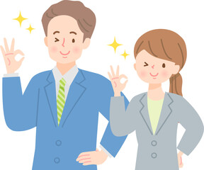 笑顔でOKサインをする若い男女