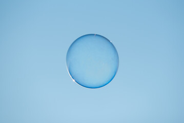 Soap bubble floating against clear blue sky close-up view - 572122330