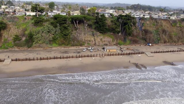 Park Rangers Assessing Damage By Storm At The Seacliff State Beach In Aptos, California, USA. aerial orbit