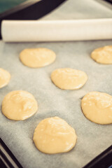 Fototapeta na wymiar circles of dough on a baking sheet