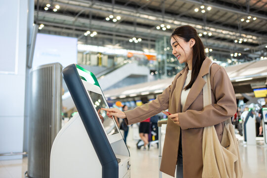 Asian Young Woman Passenger Check In At Counter In The Airport Terminal