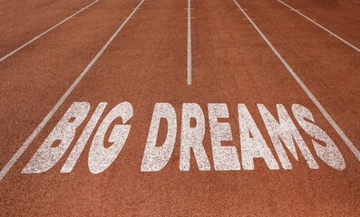 Big Dreams written on running track, New Concept on running track text in white color