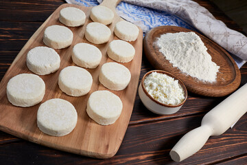 raw cottage cheese pancakes on the wooden board