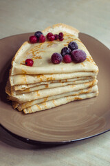 A stack of pancakes on a saucer
