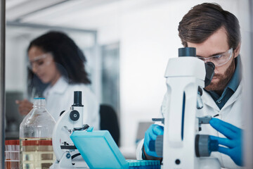 Man, doctor and forensic science with microscope for examination, experiment or test at the...