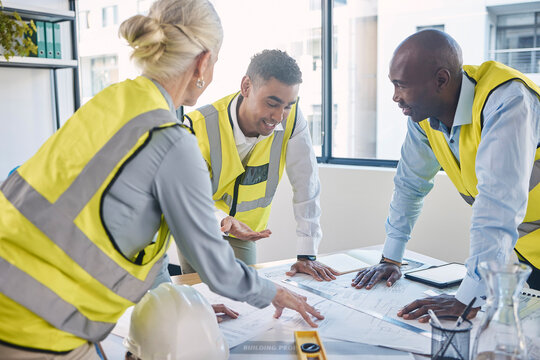 Architect, building and construction team in planning strategy, blueprints or meeting for project layout at office. Group of diverse engineers or contractors discussing floor plan or architecture