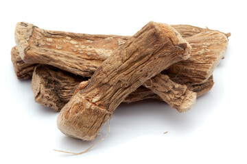 Closeup of Dry Sweet flag or Vach (Acorus calamus) roots, isolated on white background.