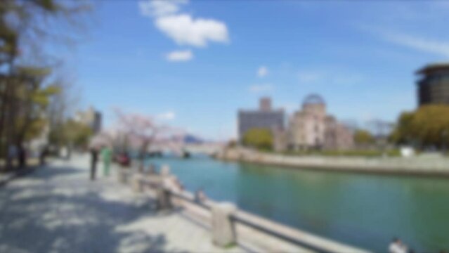 ぼかし背景素材: 桜花見を楽しむ人々で賑わう春の広島平和記念公園を歩きながらPOVショット 4K  2022年4月1日