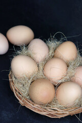 Beautiful white Chicken eggs in a wooden basket. Hen eggs. brown Chicken Eggs online shopping product photography. copy space.